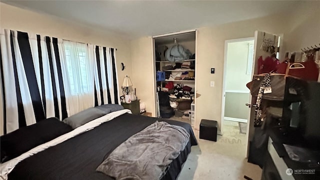 bedroom with light colored carpet and a closet