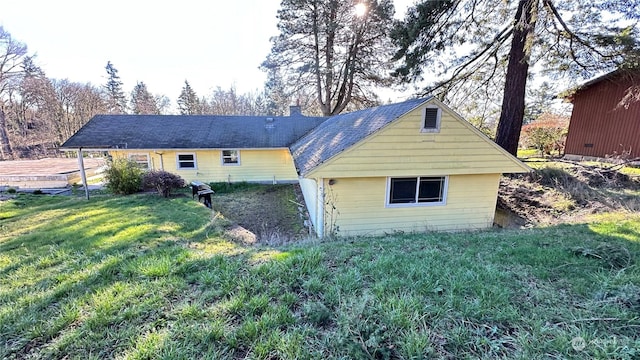 rear view of property featuring a yard