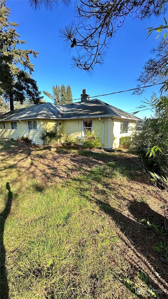 view of side of property featuring a yard