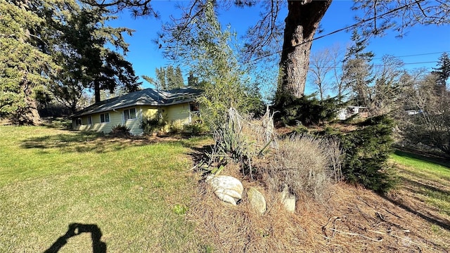 view of home's exterior with a lawn