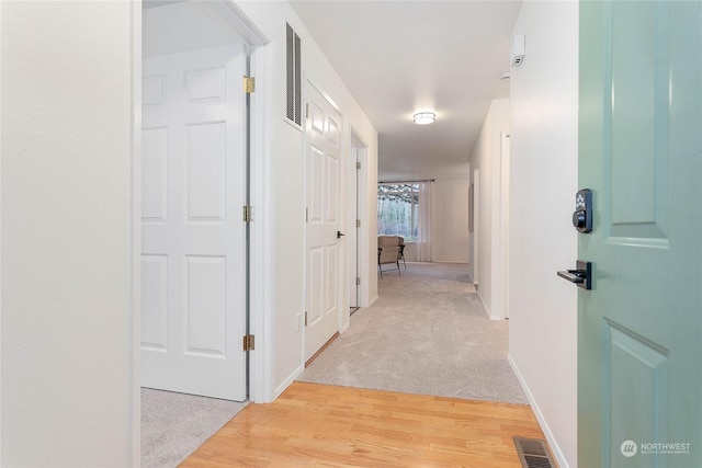 hallway with light hardwood / wood-style flooring