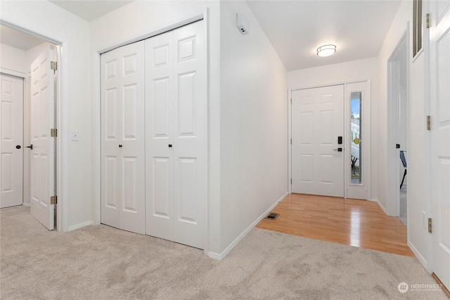 view of carpeted foyer entrance