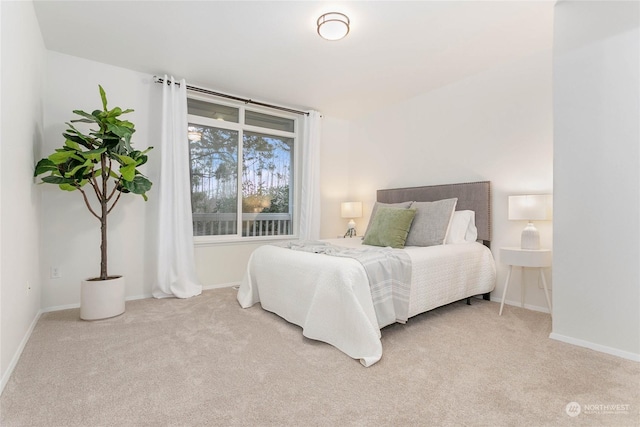 bedroom featuring light carpet