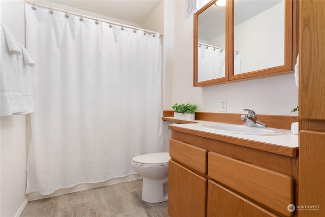 bathroom featuring hardwood / wood-style flooring, vanity, and toilet