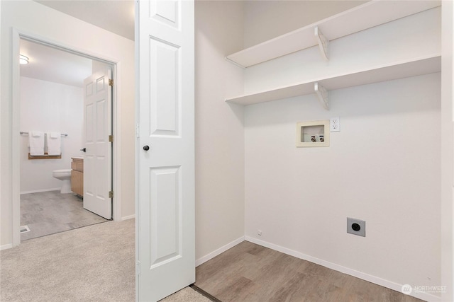 laundry area featuring hookup for an electric dryer, light wood-type flooring, and hookup for a washing machine