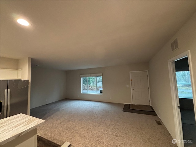 living room featuring dark carpet and lofted ceiling