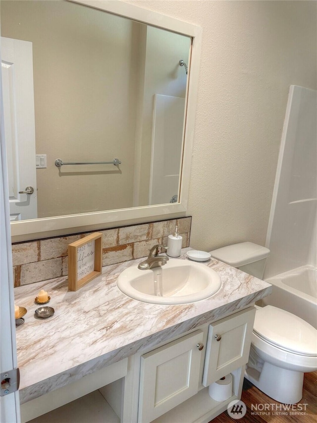 full bath with toilet, bathing tub / shower combination, and vanity