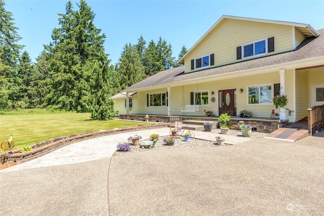 country-style home with covered porch and a front yard