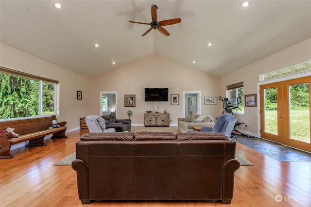 living room featuring ceiling fan, french doors, high vaulted ceiling, and light hardwood / wood-style flooring