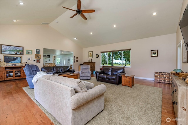 living room featuring ceiling fan, hardwood / wood-style floors, and high vaulted ceiling