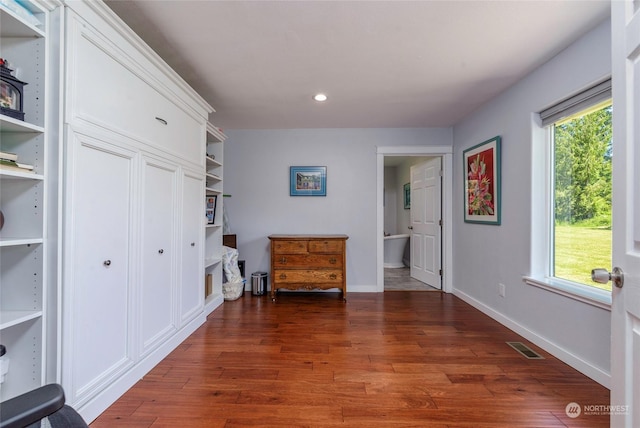 corridor featuring dark hardwood / wood-style floors