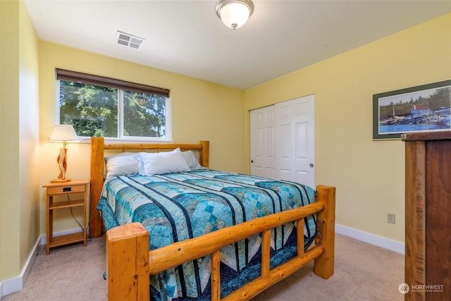 bedroom featuring light colored carpet and a closet