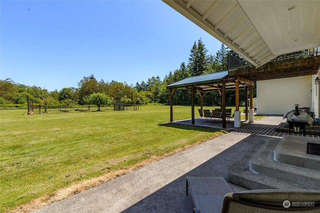 view of property's community with a lawn and a patio