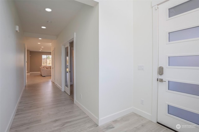 corridor with light hardwood / wood-style floors