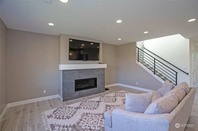 living room featuring a fireplace and light hardwood / wood-style flooring