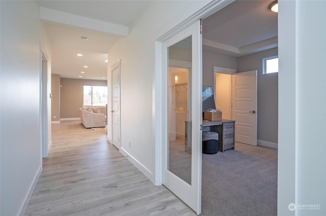 hallway with light hardwood / wood-style flooring