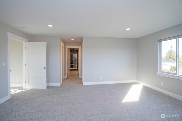 unfurnished room featuring light colored carpet