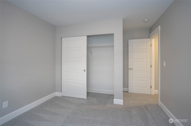 unfurnished bedroom featuring a closet and carpet