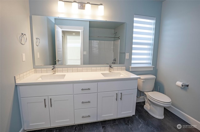 bathroom with vanity, tasteful backsplash, and toilet