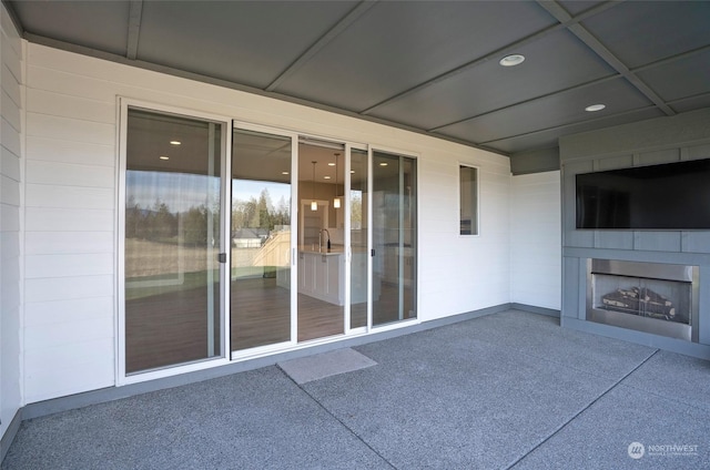 view of patio with an outdoor fireplace