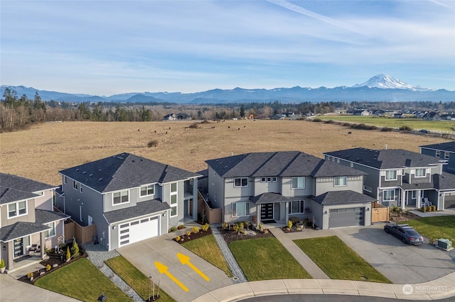 birds eye view of property with a mountain view