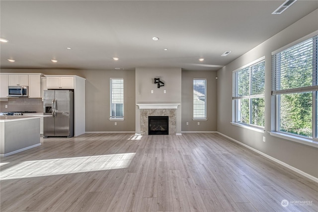 unfurnished living room featuring light wood-type flooring