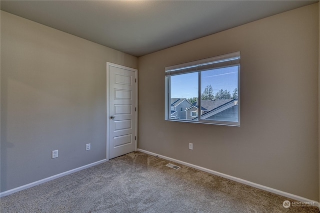 spare room featuring carpet floors