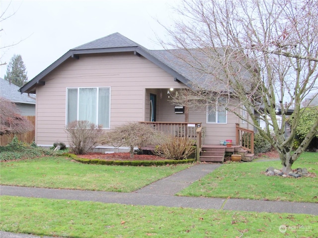 view of front of property featuring a deck and a front lawn