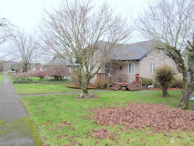 single story home with a deck and a front lawn