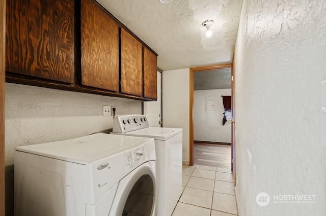 319 4th Ave, Mabton, WA 98935 - washroom featuring washing machine and clothes dryer, light tile patterned floors, and cabinets