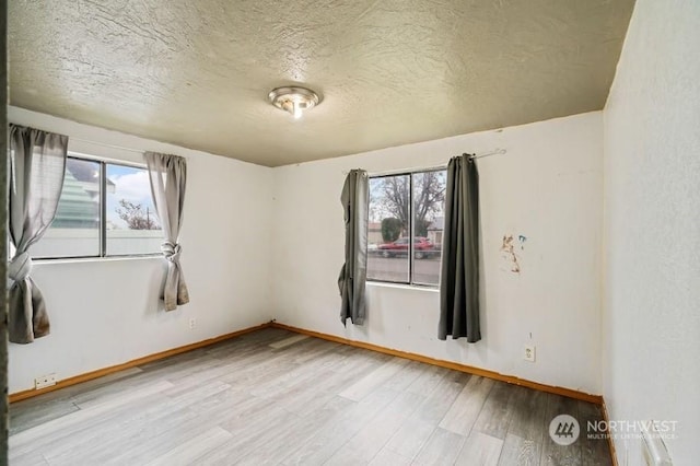 319 4th Ave, Mabton, WA 98935 - spare room featuring a textured ceiling and light wood-type flooring