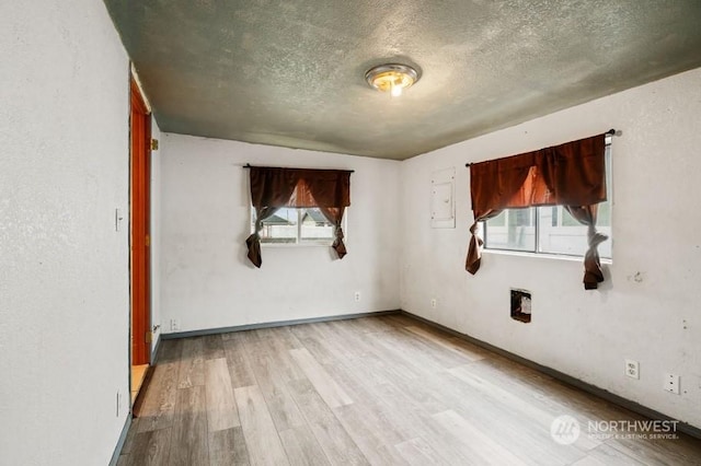 319 4th Ave, Mabton, WA 98935 - unfurnished room with a textured ceiling and light hardwood / wood-style flooring