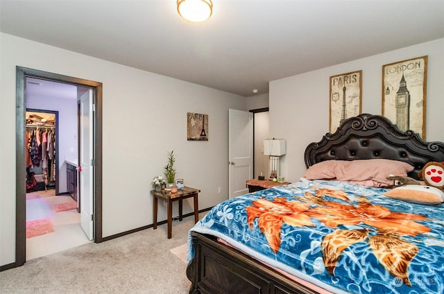 carpeted bedroom with a walk in closet and a closet