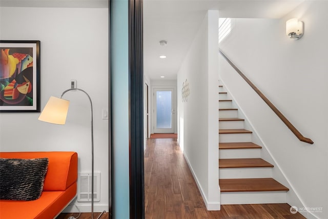 hallway with hardwood / wood-style floors