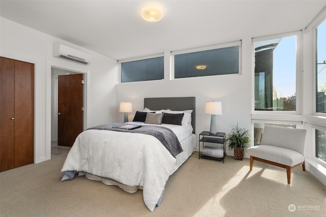 bedroom with carpet floors, a wall unit AC, and a closet