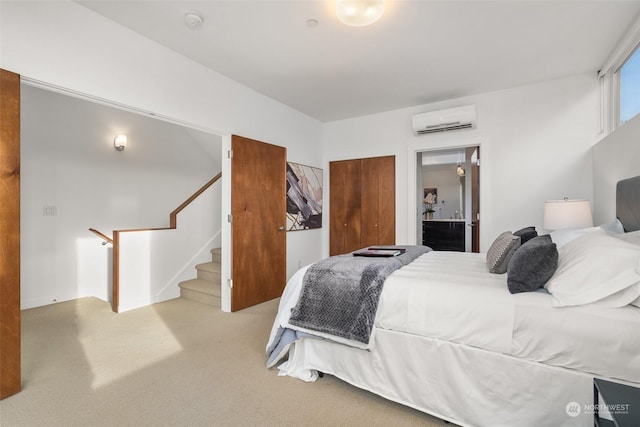 carpeted bedroom featuring an AC wall unit