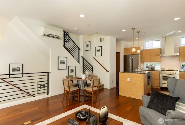 living area with dark wood-style floors, a wall mounted AC, and recessed lighting