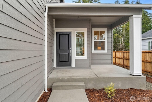 view of exterior entry with fence