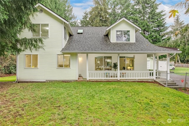 rear view of house with a lawn and covered porch