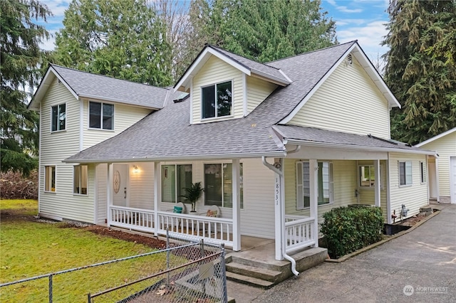 view of front of house featuring covered porch and a front lawn