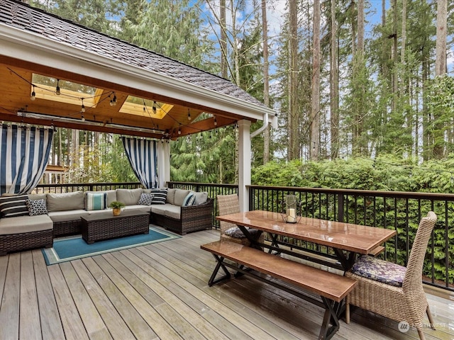 wooden deck featuring outdoor lounge area and a gazebo