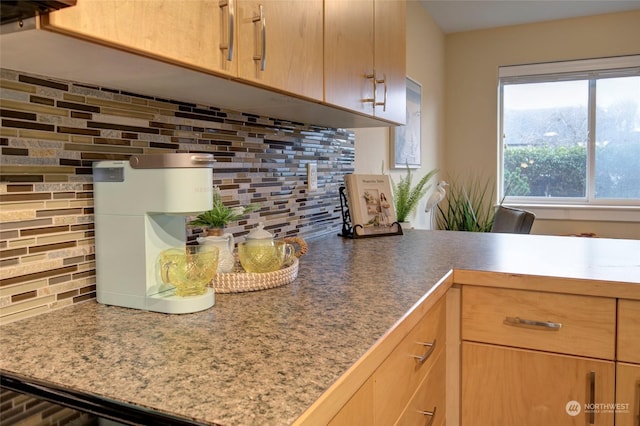 kitchen featuring backsplash and light brown cabinetry