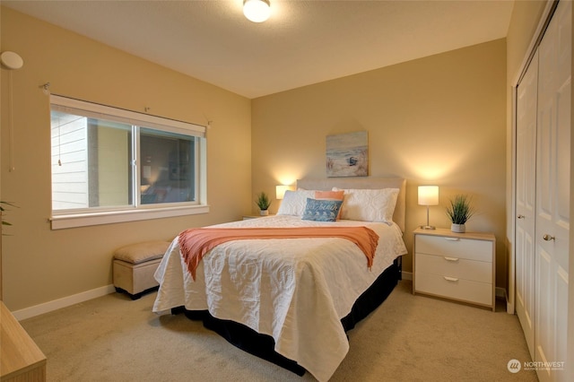 bedroom with light colored carpet and a closet