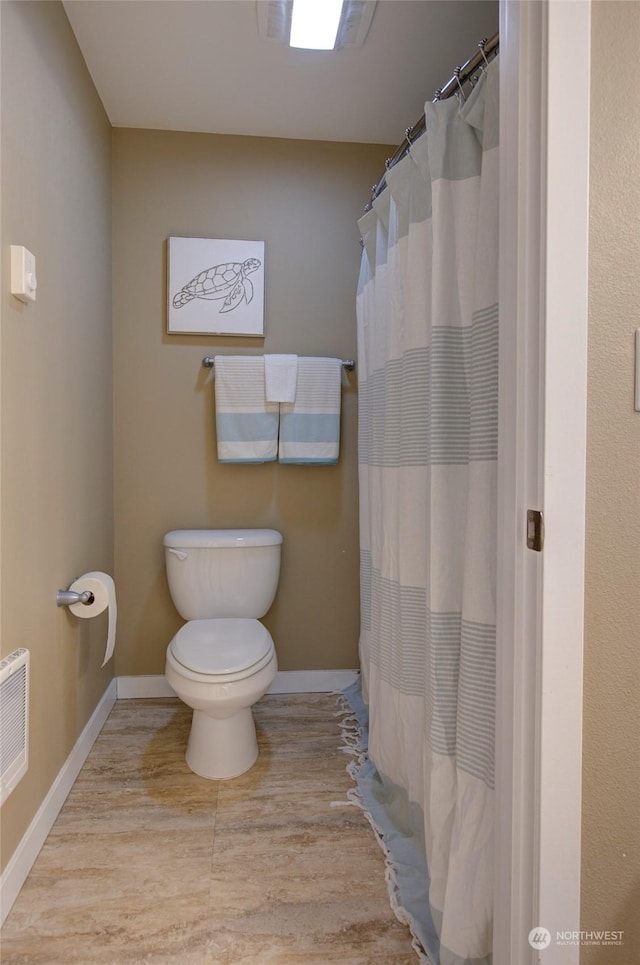 bathroom with toilet and wood-type flooring