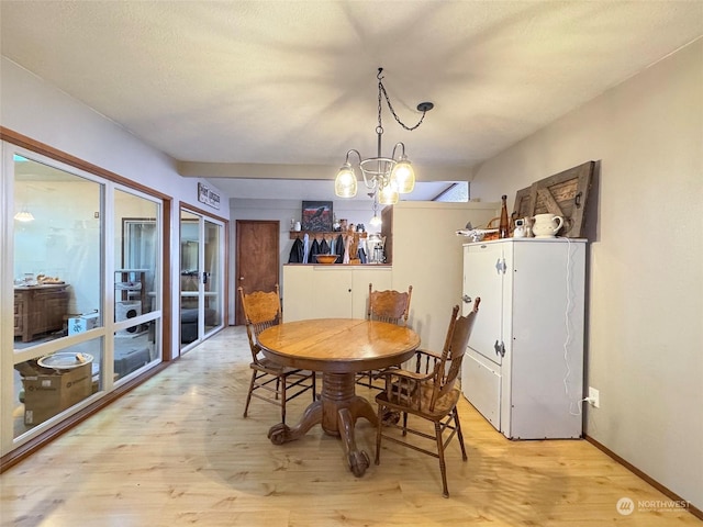 dining area featuring a chandelier and light hardwood / wood-style floors