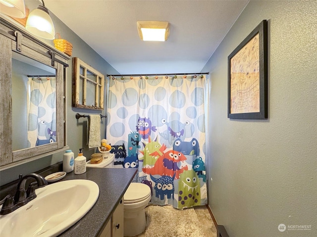 bathroom with vanity, toilet, and walk in shower