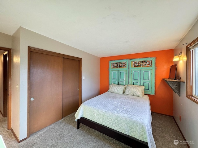 carpeted bedroom featuring a closet