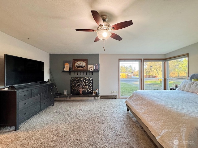 carpeted bedroom with access to outside, ceiling fan, and a textured ceiling