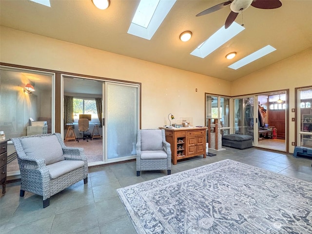 living area with tile patterned flooring, ceiling fan, and lofted ceiling