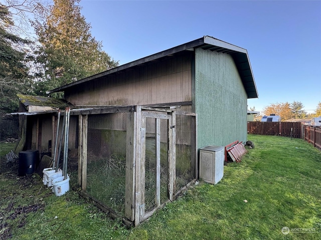 view of outbuilding featuring a lawn